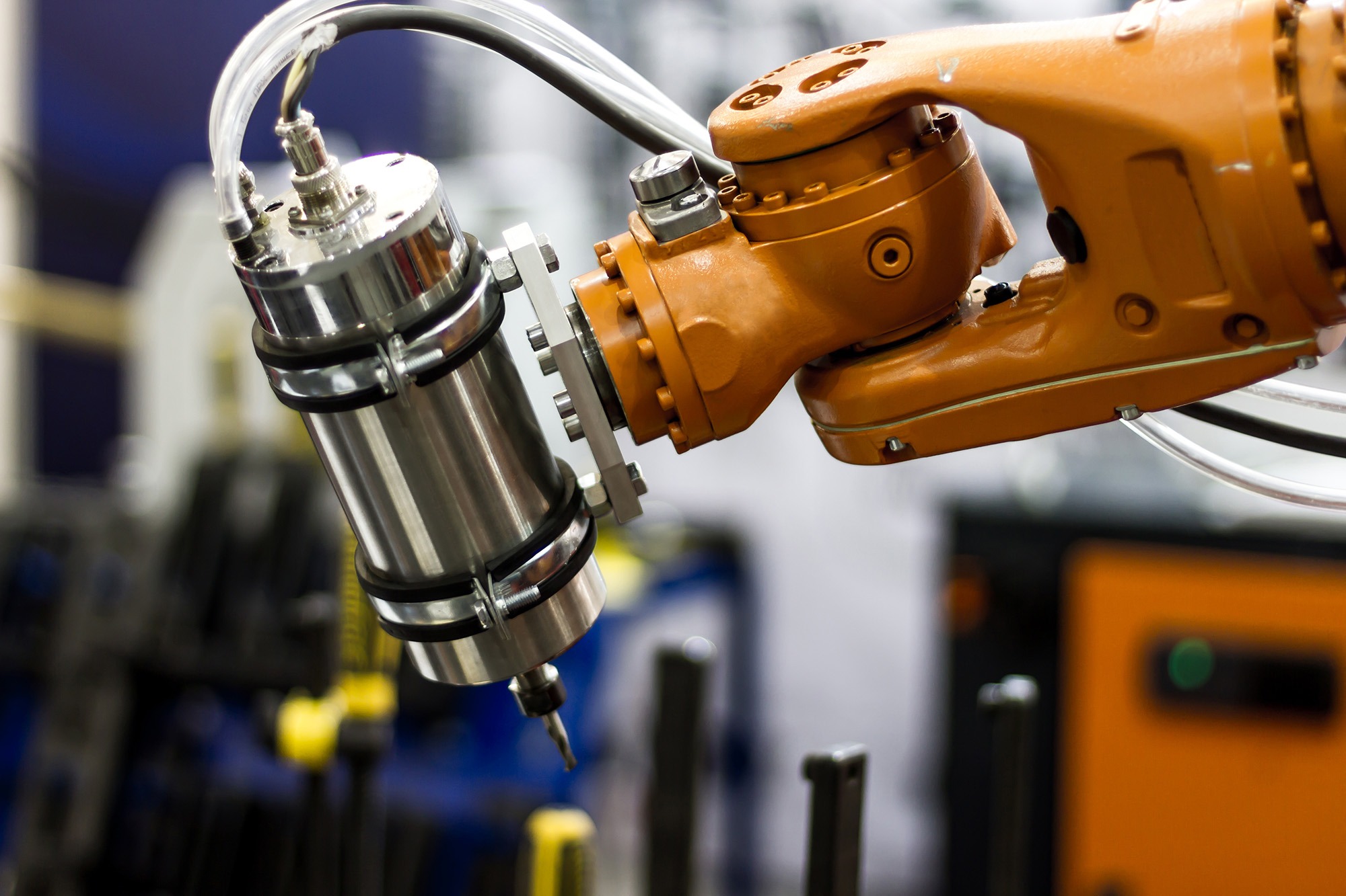 Industrial robotic arm equipped with a precision tool, showcasing advanced automation technology in a manufacturing environment.